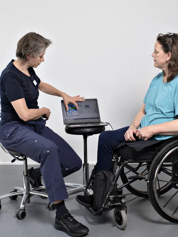 En fysioterapeut fra Specialrådgivningen rådgiver en kørestolsbruger. HandicapBilistCentret arbejder tæt sammen med Specialrådgivningen. Har en borger behov for både en ny kørestol og ny handicapbil, har vi mulighed for at samarbejde i den konkrete sag.